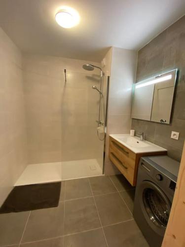 une salle de bain avec une machine à laver et un lave-linge dans l'établissement Perle de Savoie A203, à Châtel