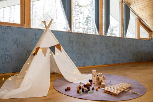 a white teepee tent on the floor in a room at Villa Metsä KARUIZAWA ヴィラメッサ軽井沢 in Karuizawa