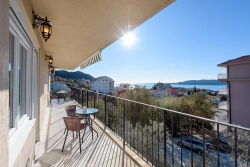 Un balcón con una mesa y vista a una ciudad. en Apartments Sunny Family, en Bečići