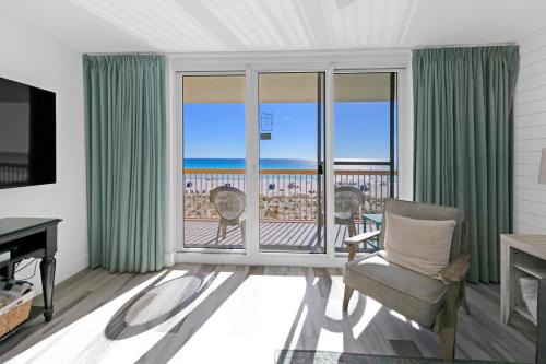 a living room with a view of the ocean at Beautiful Updated Pelican Beach Unit!!! in Destin
