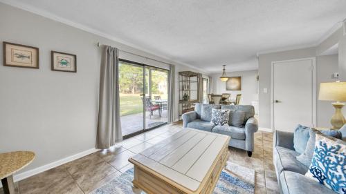 a living room with a couch and a table at Cozy renovated ground floor unit - Golf Villa - on the Golf Course in Destin