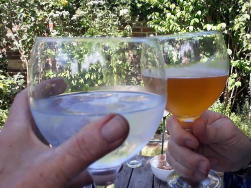 a person holding a glass of beer on a table at One Holyrood Hotel & Cafe in Newport