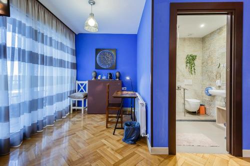 baño con paredes azules y ducha a ras de suelo en Hostal Rodas Pamplona, en Pamplona