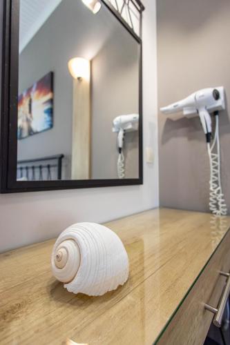 a roll of toilet paper on a counter in front of a mirror at Aurora Premium Hospitality in Parga