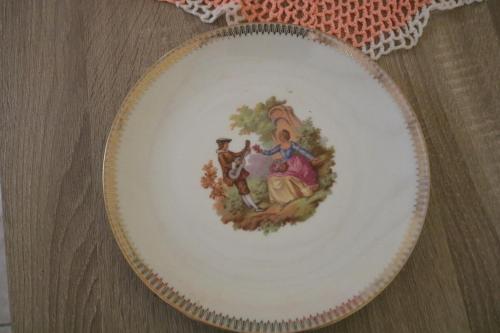 a plate with a painting of two people and a dog at Emmanuel in Sainte-Rose