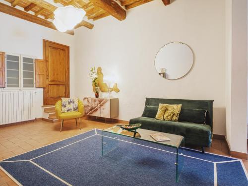 a living room with a green couch and a glass table at Michael's Home - Cozy apartment in the heart of Lucca in Lucca