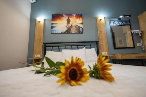 a bedroom with a bed with a sunflower on it at Aurora Premium Hospitality in Parga