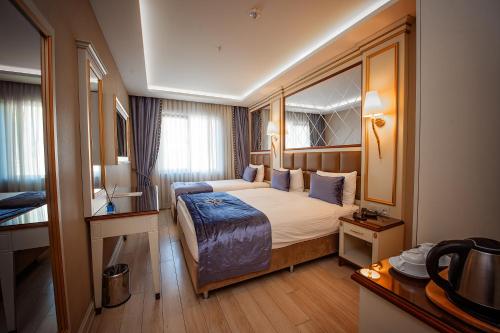 a hotel room with a bed and a desk at Grand Marcello Hotel & SPA in Istanbul