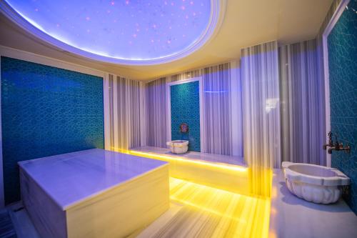 a large bathroom with a large tub and a window at Grand Marcello Hotel & SPA in Istanbul