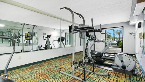 a gym with tread machines and a mirror at Home 1 Suites Extended Stay - Kissimmee in Kissimmee