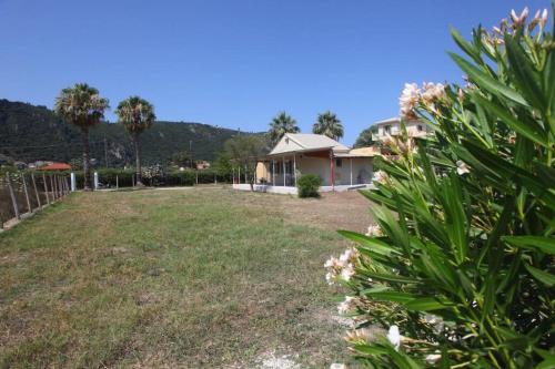 a yard with a house in the background at Olga Home Agios Ioannis Lefkada - Lefkada BnB in Lefkada Town