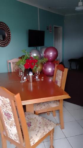 a dining room table with flowers and balloons on it at eagles inn in Richards Bay