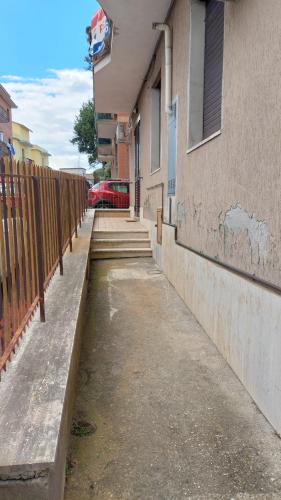 a sidewalk next to a building with a fence at Mary T House in Campagnano di Roma