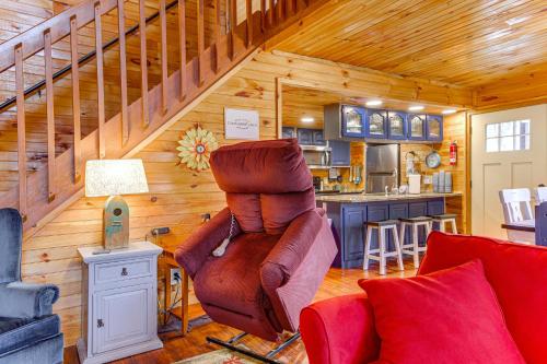 a living room with a staircase in a wooden house at Easy-Access Pigeon Forge Cabin with Hot Tub! in Pigeon Forge