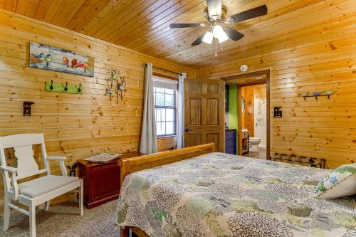 a bedroom with a bed and a ceiling fan at Easy-Access Pigeon Forge Cabin with Hot Tub! in Pigeon Forge