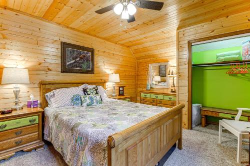 a bedroom with a bed in a wooden cabin at Easy-Access Pigeon Forge Cabin with Hot Tub! in Pigeon Forge