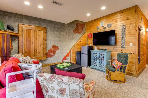 a living room with a couch and a tv at Easy-Access Pigeon Forge Cabin with Hot Tub! in Pigeon Forge