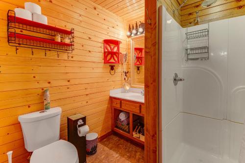 a bathroom with a toilet and a sink and a shower at Easy-Access Pigeon Forge Cabin with Hot Tub! in Pigeon Forge