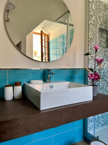 a bathroom with a white sink and a mirror at Il Melograno in Itri