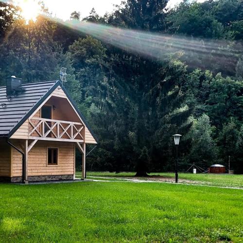 a house in a field with a sprinkler at Siedlisko nad Białką in Głuchołazy
