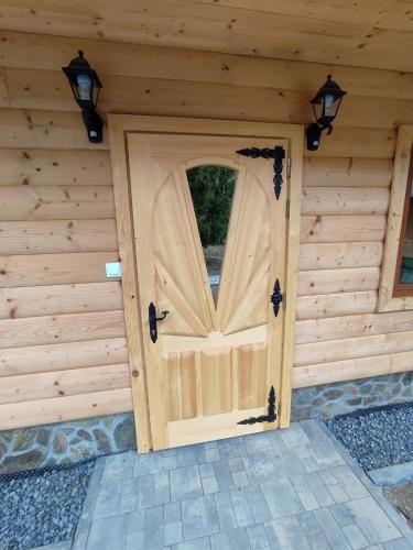 a wooden door in the front of a building at Siedlisko nad Białką in Głuchołazy