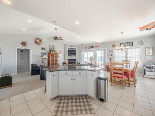 a kitchen and living room with a table and chairs at Serendipity in Surf City