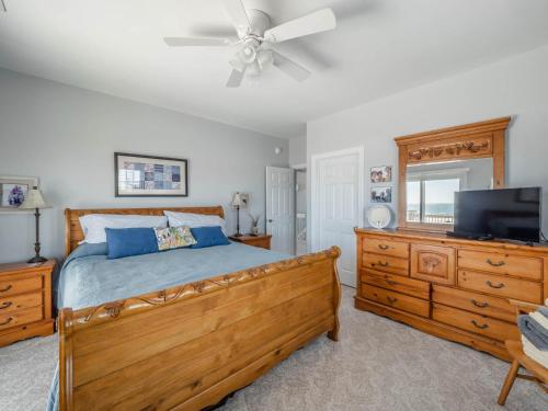 a bedroom with a bed and a flat screen tv at Serendipity in Surf City