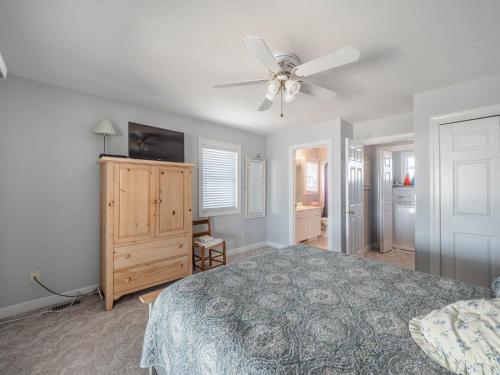 a bedroom with a bed and a ceiling fan at Serendipity in Surf City