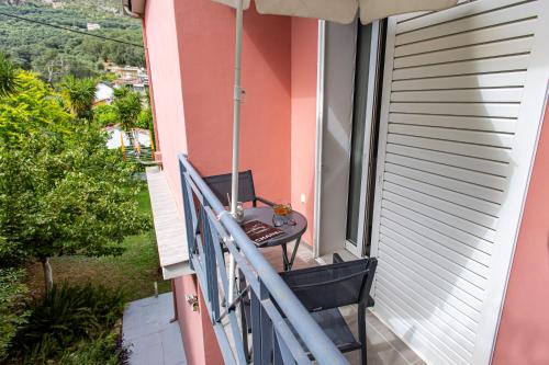 a balcony with a table and a laptop on it at Aurora Premium Hospitality in Parga