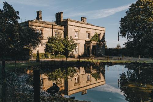 an old house with its reflection in a pond at Calthwaite Hall Bed & Breakfast in Penrith