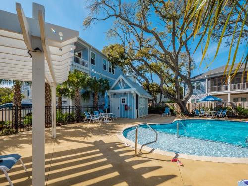 a house with a swimming pool and a building at Serenity By the Sea in Kure Beach