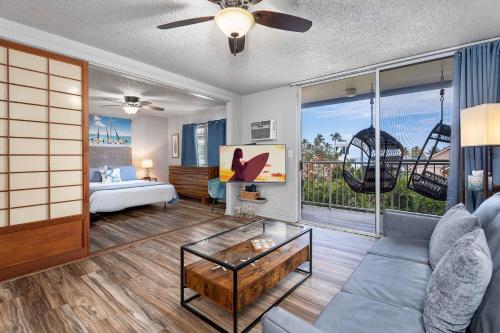 a living room with a bed and a couch at Kailua Village#201 in Kailua-Kona