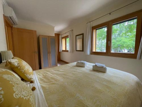 a bedroom with a large bed with two towels on it at No14 Lote B, Quinta da Belavista in Luz