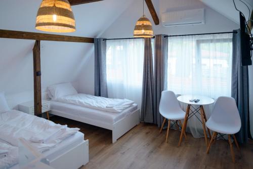 a bedroom with a bed and a table and chairs at Casa Gherman Cheia in Cheia