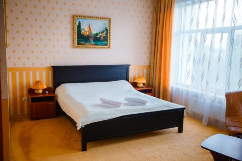 a bedroom with a bed with two towels on it at LidoLux in Bălţi