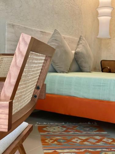 a bed with a wooden frame and pillows on it at FUTURA ROOM&RELAX in Termoli