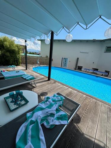 a swimming pool with a table with a blue bow at Opal in Klagenfurt