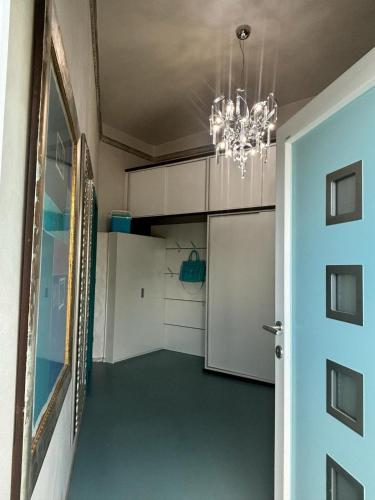 a hallway leading to a garage with a chandelier at Opal in Klagenfurt