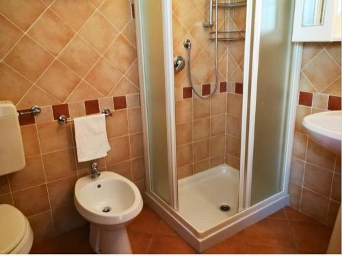 a bathroom with a shower and a toilet and a sink at Al Mulino di Sant'Eufemia in La Strada