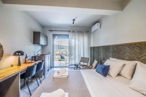 a hotel room with a bed and a dining room at blue symphony suites and apartments in Nikiana