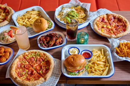 a wooden table topped with different types of food at Generator Berlin Alexanderplatz in Berlin