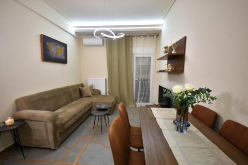 a living room with a couch and a table at Eugenia's Luxury Apart in Volos