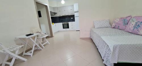 a living room with a couch and a table and chairs at View Saranda Center in Sarandë