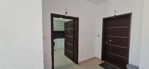 a room with a closet with a mirror and a door at View Saranda Center in Sarandë