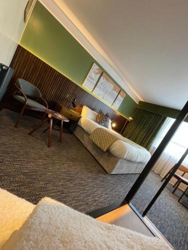 a hotel room with a bed and a chair at The Fairway in Barnsley