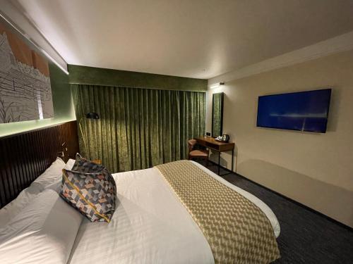 a hotel room with a bed and a desk at Hotel Nineteen in Barnsley