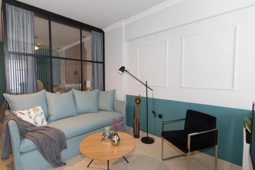 a living room with a blue couch and a table at Phaedra's Studios in Kolymbari in Chania Town