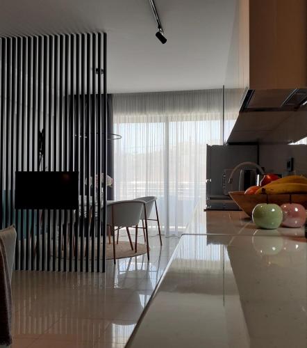 a kitchen with a table and a dining room at Phaedra's Studios in Kolymbari in Chania Town