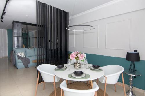 a white dining room with a white table and chairs at Phaedra's Studios in Kolymbari in Chania Town