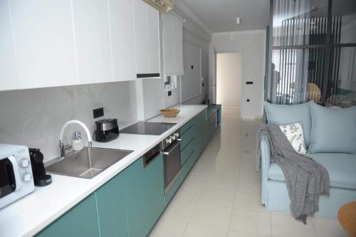 a kitchen with blue and white cabinets and a sink at Phaedra's Studios in Kolymbari in Chania Town